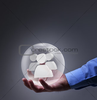 Male hand holding glass sphere with social networking symbol