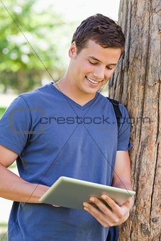 Close-up of a young man using a touch pad