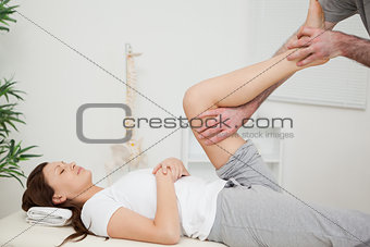 Serious brunette woman lying on a medical table