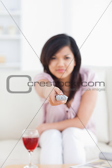 Blurred woman holding a television remote