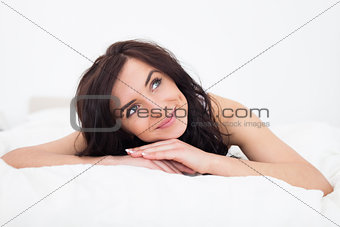 Peaceful brunette woman lying on her blanket