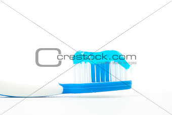 Blue toothpaste on a toothbrush