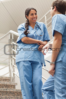 Smiling nurse talking with a colleague