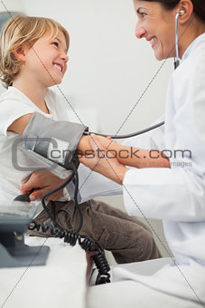 Doctor examining blood pressure of a child