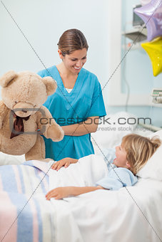 Nurse holding a teddy bear