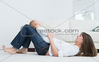 Mother lying on the floor with a baby