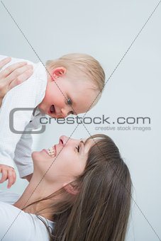 Smiling mother holding her baby
