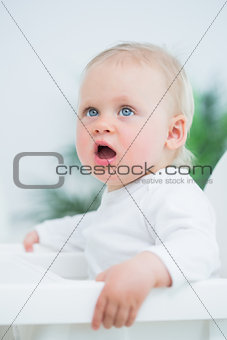 Baby sitting on a high chair