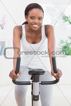 Black woman doing exercise bike
