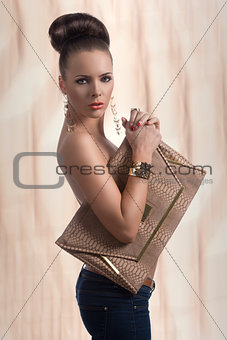 fashion brunette in jeans with big bag and body in profile