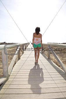 walking on wooden lonely footbridge