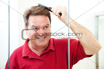 Handsome Mature Man Brushes His Hair