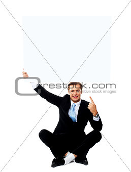 Business professional pointing up towards blank placard