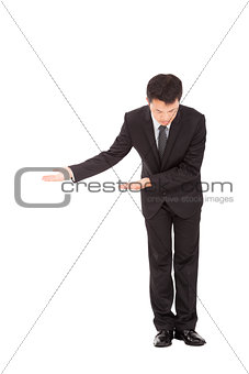 full length of asian businessman with bow and welcome gesture