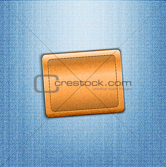 Brown leather label on blue jeans background