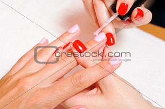 Skin and nail care. Applying of the Transparent varnish. 