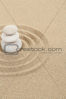 balance zen stone in sand with circles