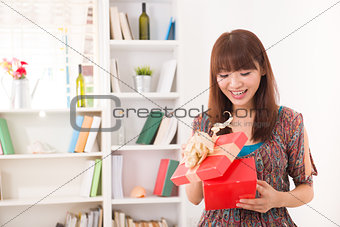 beautiful chinese woman happy receiving gift with lifestyle back