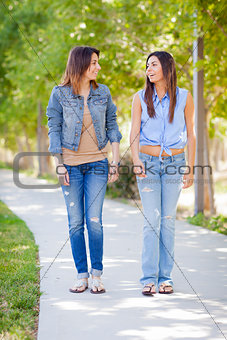 Young Adult Mixed Race Twin Sisters Walking Together