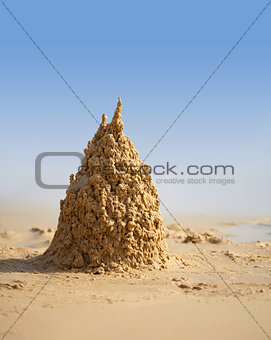 Surreal sand castle on beach