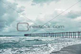 Old jetty over the stormy sea