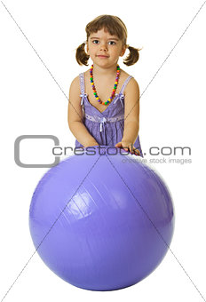 Little girl with a large rubber ball on white