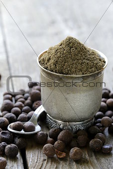 ground black pepper on a wooden table
