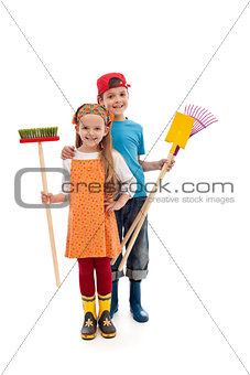 Kids with gardening utensils and rubber boots - isolated