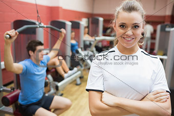 Female trainer smiling in front of class