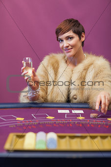 Woman drinking at table of a casino
