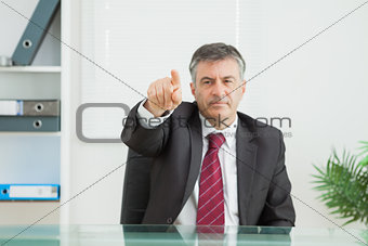 Business man pointing seriously