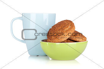 Cup of milk and bowl with cookies
