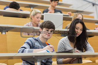 Students listening and taking notes in a lecture
