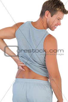 Man grimacing because of a back pain