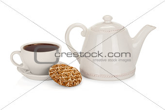 Cup of tea with teapot and a coockie on white