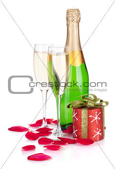 Two champagne glasses, christmas decor and rose petals