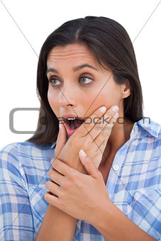 Astonished young woman with hands on chin