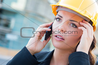 Worried Female Contractor Wearing Hard Hat on Site Using Phone