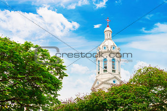 White church spire on blue cloudy background