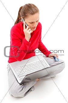 Girl talking on the phone with laptop in her lap