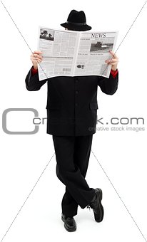 Man in black covering himself with newspaper