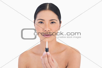 Calm attractive model holding lip gloss