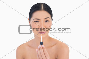 Funny attractive model holding lip gloss