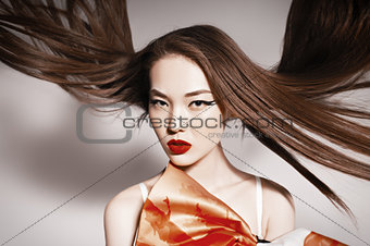 Photo of beautiful asian woman with magnificent hair. Fashion