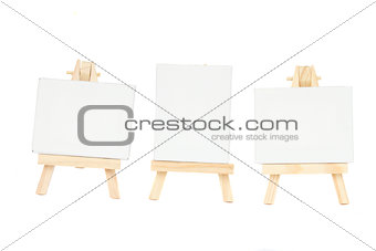 set of easels with blank canvas