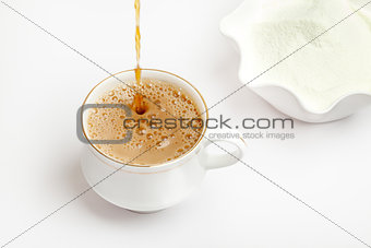 Cup of tea with dairy milk powder