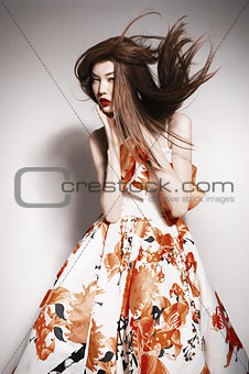 young beautiful asian brunette in gorgeous dress, motion shot