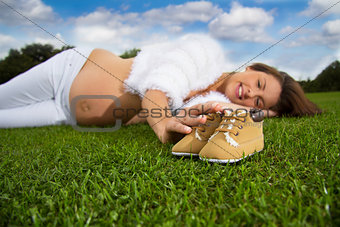 Pregnant woman lying on the grass 