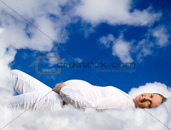 Pregnant woman lying on clouds