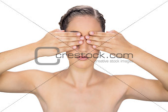 Unsmiling woman hiding her eyes
